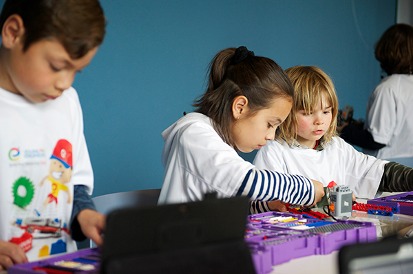 Children participating in a STEM summer camp activity in Calgary using LEGO kits