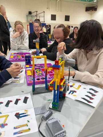 Participants building LEGO engineering models at a Young Engineers workshop