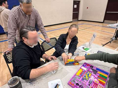 Participants building LEGO engineering models at a Young Engineers workshop