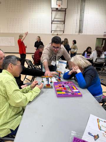 Participants building LEGO engineering models at a Young Engineers workshop