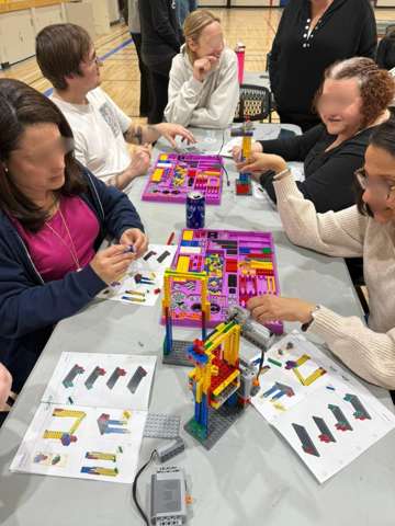 Participants building LEGO engineering models at a Young Engineers workshop