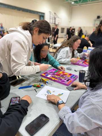 Participants building LEGO engineering models at a Young Engineers workshop