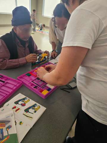 Participants building LEGO engineering models at a Young Engineers workshop