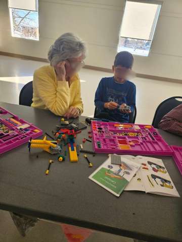 Participants building LEGO engineering models at a Young Engineers workshop